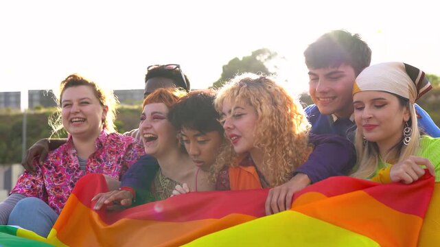 Young multiracial people having fun and celebrating gay pride parade outdoor - LGBT, love and equality concept