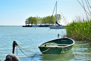 Small green rowing boat moored by the shore of Lake Balaton near Révfülöp pier, Hungary. © E.R.Dora
