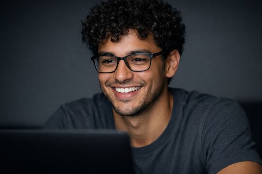 Smiling student man working on laptop against dark background. Ai generative