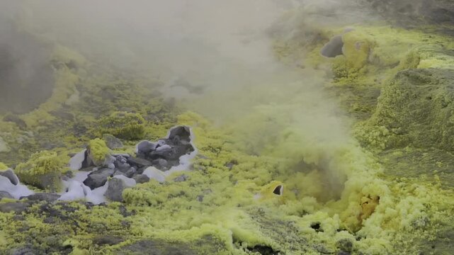 Close-up of vibrant yellow sulfur crystals on a fumarole field. Natural mineral deposits on the slopes of Vulcano Islands, Italy.