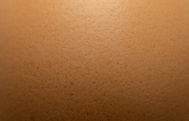 Extreme close-up of brown eggshell texture with natural speckles,Macro,A high-detailed macro shot revealing the intricate porous surface and organic brown patterns of a fresh chicken eggshell. © banjongseal324