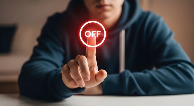 Young person's finger reaching for a glowing red 'OFF' button, symbolizing the crucial decision to power down, disconnect from technology, or embrace a digital detox for improved well-being