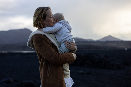 Authentic moment of love and connection between mother and toddler near the sea