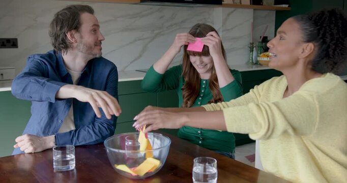 Friends at Home Together Playing Game in Kitchen, having Fun