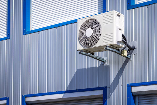 Split pump installed on a wall of industrial building, heating and cooling system