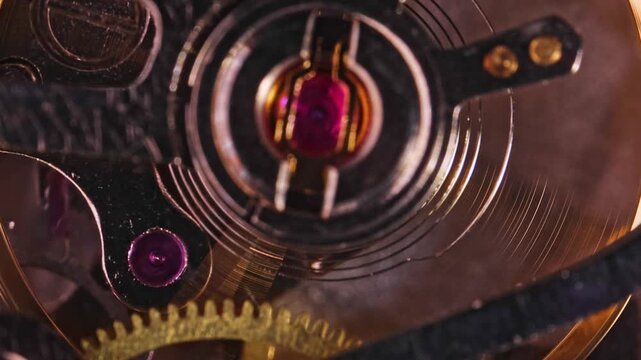 Close-up of intricate watch mechanism showcasing detailed inner components such as gears, springs, and jewel bearings.