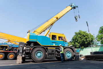 Obraz premium Crane safety inspection mobile crane construction engineer worker Industrial crane safety inspection with construction worker checking mobile