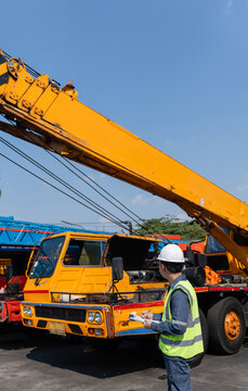 Crane safety inspection construction engineer hardhat clipboard worker maintenance Technician performs crane safety inspection construction site