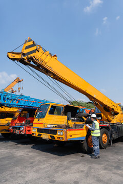 Crane safety inspection engineer maintenance construction Crane safety inspection during maintenance by engineer using checklist beside mobile