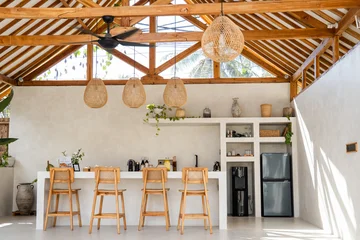 Fotobehang Horeca Stylish kitchen bar area with wicker lamps and exposed timber ceiling in a relaxed setting  © BUDDHA