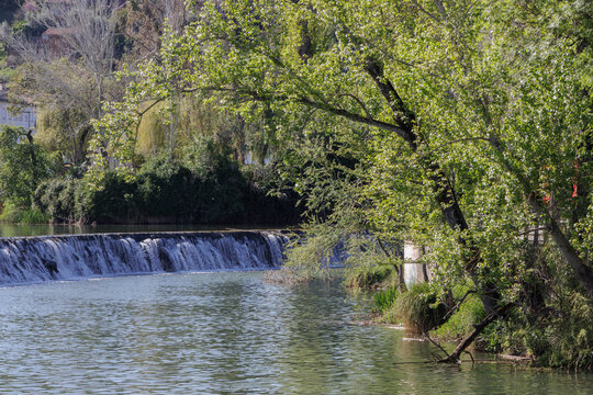 Nab&atilde;o River flowing over weir in Tomar Portugal