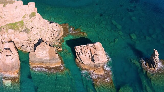 Greece Crete Triopetra Beach 4K Drone Video Close Up Flight Over Three Rocks Stacks Scenic Wild Empty Coast with Vertical Cliffs and Mountains Background Mediterranean Nature Travel