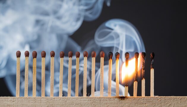 Matchstick burning in a row with smoke showing chain reaction metaphor, sequence