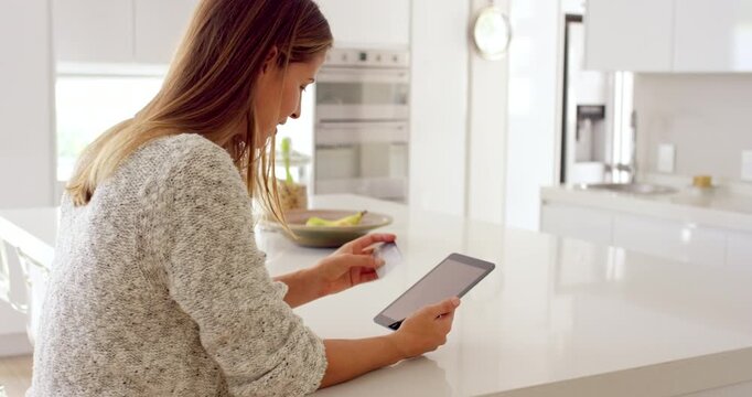 Woman, home and tablet with credit card for online shopping or wireless transaction in kitchen. Female person, shopper or technology with debit or banking app for ecommerce, purchase or payment