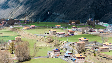 Spring Landscape of Xinduqiao, Sichuan: Tibetan Village Nestled in Green Valley with Mountain Backdrop © jiahong