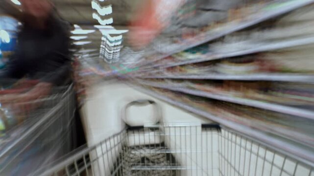 Timelapse from a shopping cart in family hypermarket, fast moving through supermarket aisle. Food store, grocery shop. POV customer trolley moving into mall. Shelves of products. Immersive experience