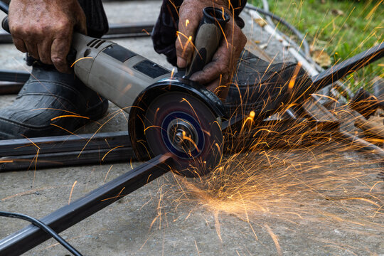 Metalworking with Angle Grinder Sparks Flying Outdoors