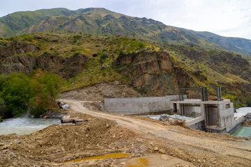 Concrete hydroelectric dam construction site in mountainous area © lucky pics
