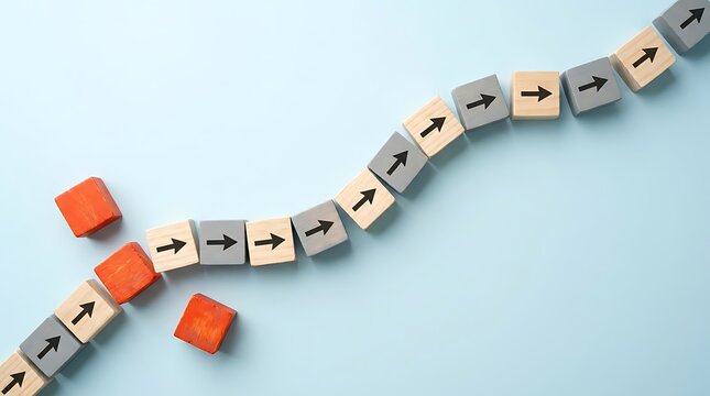 Disrupted wavy path of wooden blocks with black arrows some red blocks falling symbolizing business challenge failure