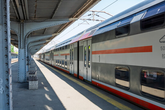 Train at station platform in Gara de Nord Bucharest Romania with people boarding and commuting by railway