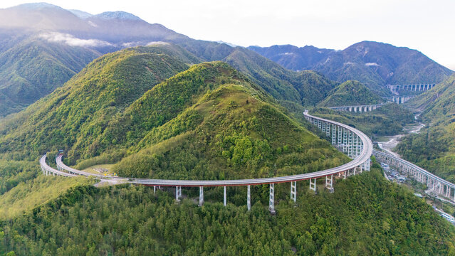 Aerial View of YaXi Highway Double Spiral Tunnel in Sichuan, China &ndash; Mountainous Elevated Road Infrastructure Amid Lush Green Valleys