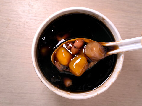 Grass jelly with taro balls and sweet potato balls is a Taiwanese snack and dessert.