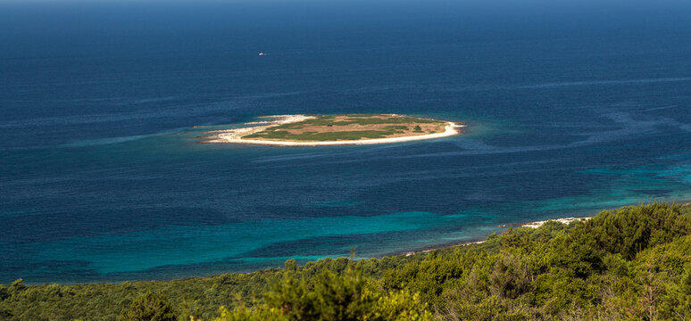 Cozy mediterranean island. Blue lagoon, island paradise. Adriatic Sea of Croatia, popular touristic destination near Primosten. Clear sea water.