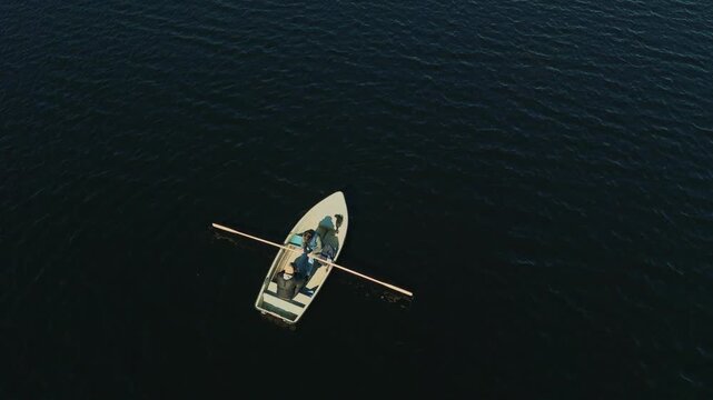 Two People Rowing on a Lake in Sweden. Drone footage from Bird's-Eye / Top View