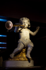 Naklejka premium Trumpeting angel statue at Amsterdam's hidden church museum. Symbol of faith, God's message, and Dutch Golden Age spirituality