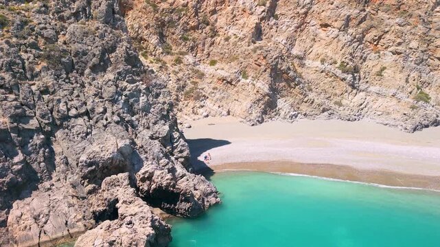Aerial view of Agiofarango beach and canyon in South Crete, Greece. Drone low flight over turquoise water to sea rocks, empty wild beach and steep cliffs. High angle reveal of scenic landscape, 4k.