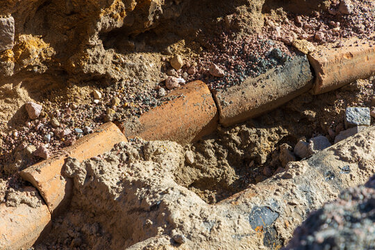 Detailed Close Up of Old Underground Clay Pipes Discovered During City Road Excavation
