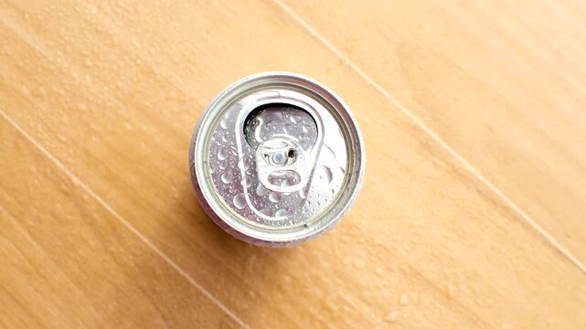 Close-up of the top of a soda can, capturing the metallic texture and drops of condensation. Close-up of the top of a soda can, capturing the metallic texture made from aluminum.