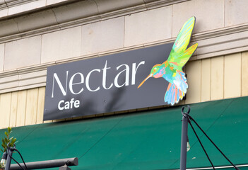 Obraz premium Nectar Cafe Sign With Colorful Hummingbird Logo
