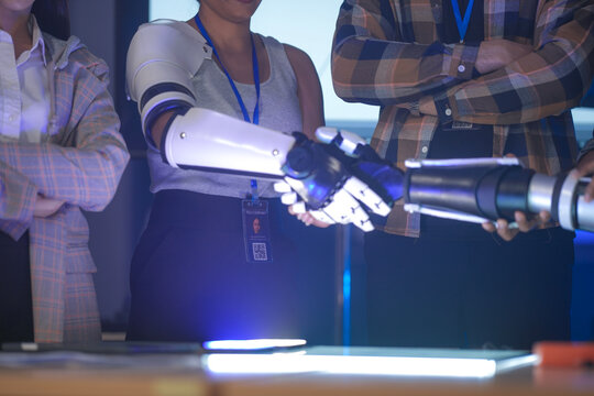 A startup team develops future medical technology. The diverse engineers test a new AI robotic prosthetic, an innovative solution for healthcare and digital transformation.