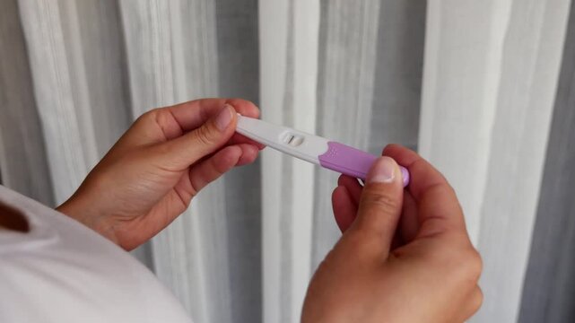 Negative pregnancy test in woman hands close-up, home medical kit with one line, family planning ongoing, trying to conceive, female health concept
