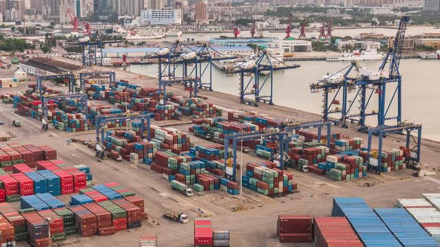 Day to night time-lapse of busy container loading and unloading operation at Xiuying Port, Haikou, Hainan Free Trade Port