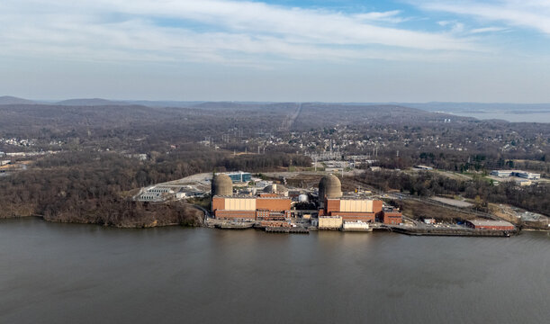 Aerial view of Indian Point Energy Center with its reactor domes and industrial buildings along the Hudson River waterfront Buchanan, New York, United States.
