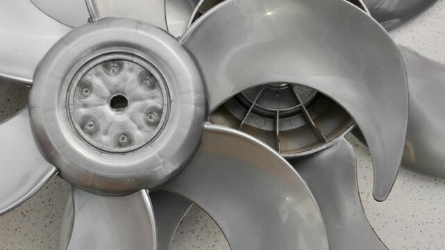 New fan impeller, disassembled into a technical composition, ready for assembly and use. Meticulous detail of newly manufactured fan impeller, disassembled for inspection and assembly.