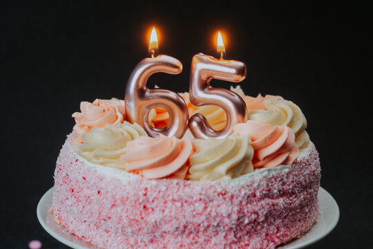 Celebration cake for a milestone birthday 65 with candles shining bright
