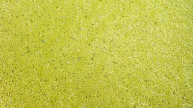 Close up of matcha texture with creamy foam and bubbles. Drink background