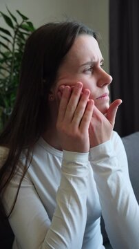 Close up of young woman suffering touching cheek, female feeling painful toothache. Teeth pain and dentistry, jaw pain, health care concept. Unhappy feel bad, diseases in oral, ache nerve and molar