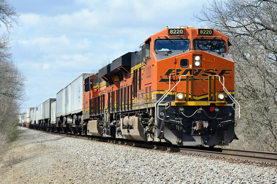 A pair of locomotives lead a Burlington Northern Santa Fe container train eastbound as it passes through rural north central Illinois.