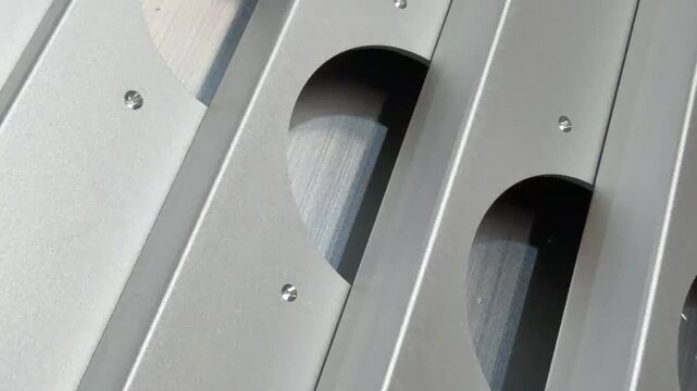 Aluminium facade profiles with meticulously drilled hinge holes, perfect for illustrating the precision and quality of construction materials in marketing materials.