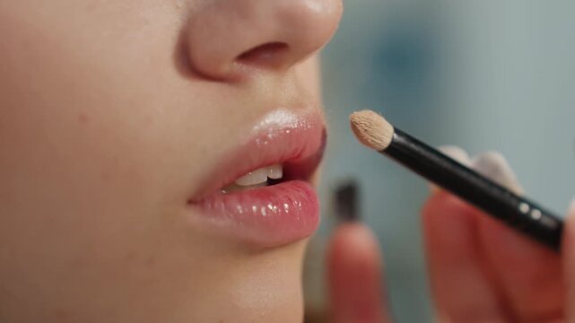 Lip Shine Application, Model Showcasing Beautifully Enhanced Glossy Lip Appearance Up Close, Detailed View Of Woman Getting Her Lips Beautifully Coated With Shiny Gloss In Professional Setting