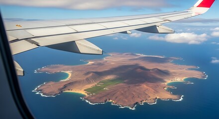 Obraz premium Aerial view of an island with coastline and ocean from an airplane window