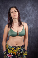 Obraz premium A woman with long dark red hair wears bikini and short. The woman is thirty-nine years old and is an Italian of Caucasian origin