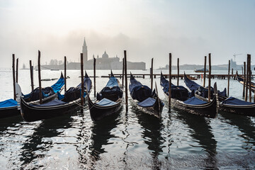 gondolas are parked at venetian canal, italy © jon_chica