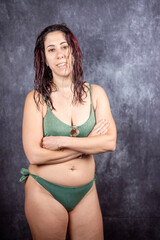 Obraz premium A woman with long dark red hair wears swimsuit. The woman is thirty-nine years old and is an Italian of Caucasian origin