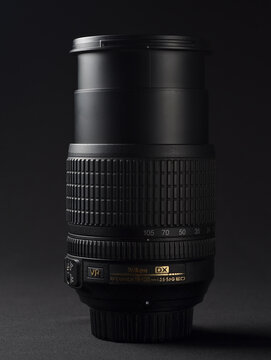 PERPIGNAN, FRANCE - MAY 5, 2026: A Nikon Nikkor 18-105mm f3.5-5.6 G ED VR lens on a black background. Professional zoom lens for digital SLR cameras featuring vibration reduction technology.