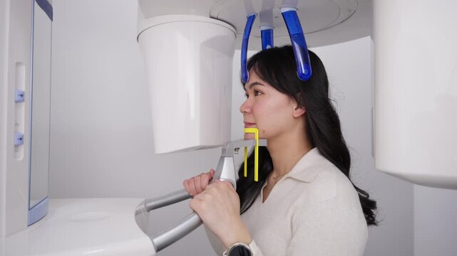 Woman receiving panoramic dental x ray scan in modern clinic